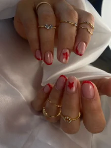 Manicura semipermanente con francesa roja y microestrellas a domicilio por nailsbyeliag Cartagena